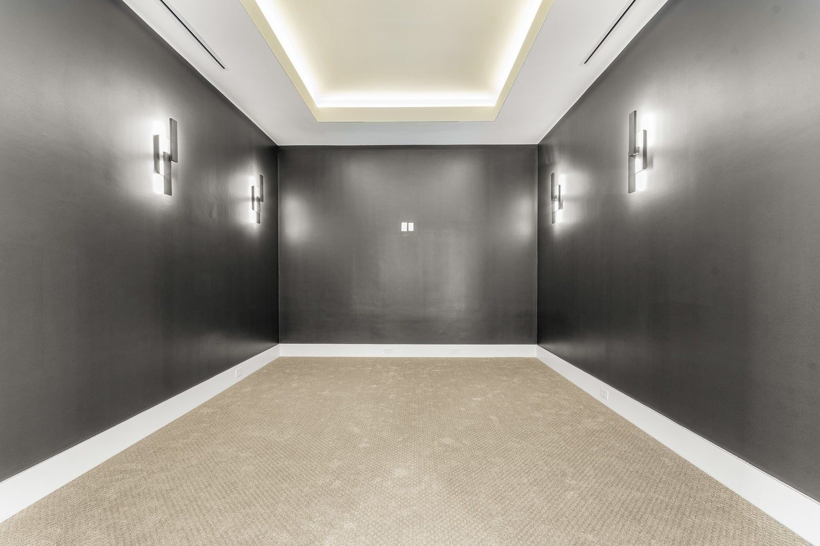 Media room with recessed cove and trimless ceiling plane