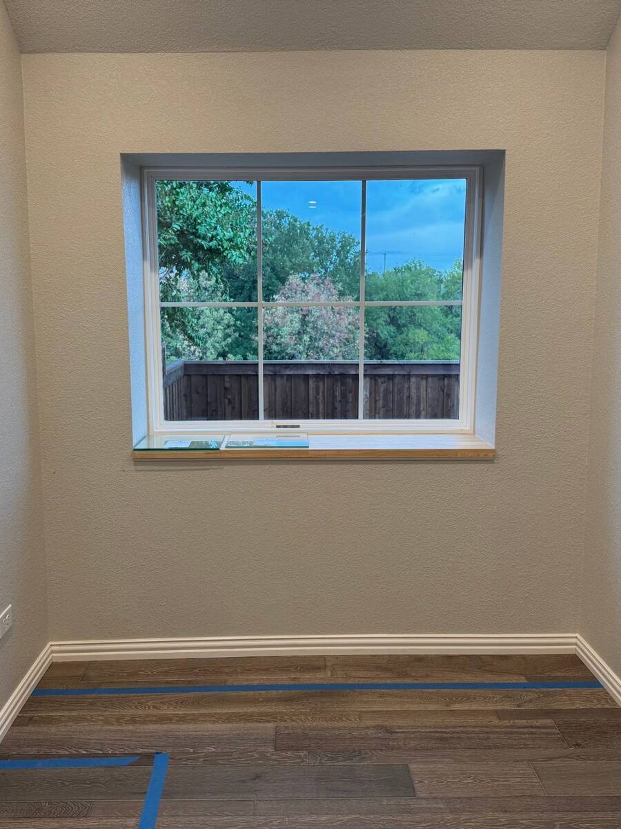 Before: empty window nook with bare walls and new wood flooring